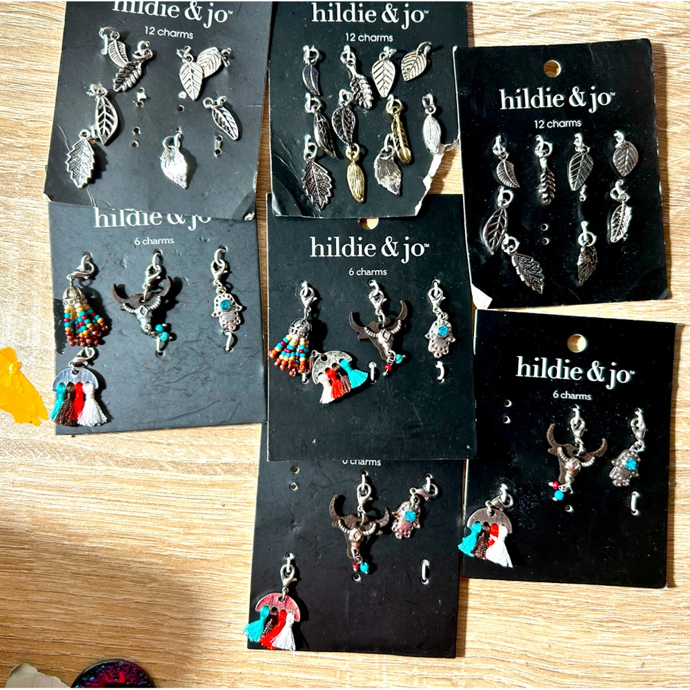 7 charm sets. 3 same and 4 the same. Some missing